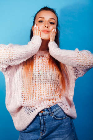 young pretty modern hipster girl posing emotional happy on blue background, lifestyle people conceptの写真素材
