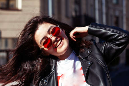 young pretty asian girl wearing sunglasses outside on big city street, lifestyle people conceptの写真素材