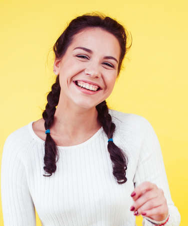 lifestyle people concept: pretty young school teenage girl having fun happy smiling on yellow...