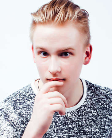 young handsome teenage hipster guy posing emotional, happy smiling against white background...