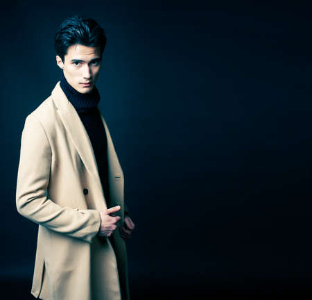 handsome asian fashion looking man posing in studio on black background, lifestyle modern people conceptの写真素材