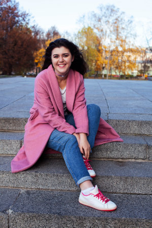 young pretty teenage brunette girl happy smiling outside, lifestyle people conceptの写真素材