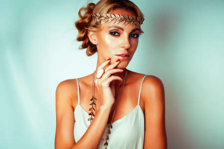young blond woman dressed like ancient greek godess, gold jewelry close up isolated, beautiful girl...