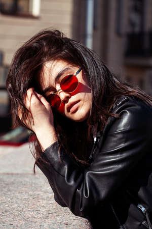 young pretty asian girl wearing sunglasses outside on big city street, lifestyle people conceptの写真素材