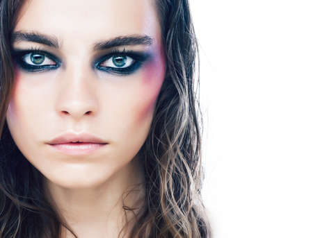 young beauty woman with makeup like shiner on face close up isolated white background, problem teenの写真素材