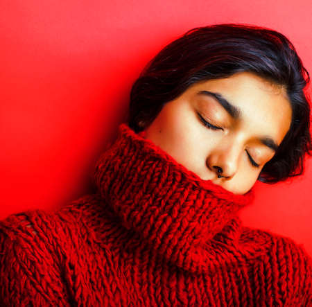 young pretty indian girl in red sweater posing emotional, fashion hipster teenage, lifestyle people conceptの写真素材