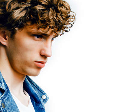 young handsome teenage hipster guy posing emotional, happy smiling against white background...