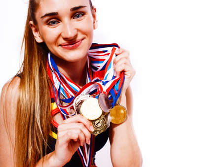 young smiling cheerleader girl with golden cups and price medals isolated on white background, lifestyle sport people conceptの写真素材