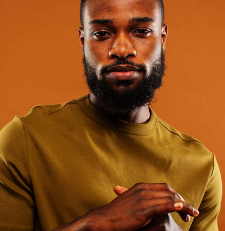 young pretty african american man posing cheerful on brown background, lifestyle people conceptの写真素材