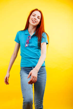 young pretty teenage girl emotional posing on yellow background, fashion lifestyle people conceptの写真素材