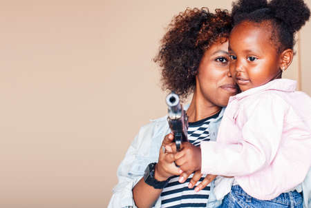 adorable sweet young african-american mother with cute little daughter, hanging at home, having fun playing smiling, lifestyle people concept, happy smiling modern familyの写真素材