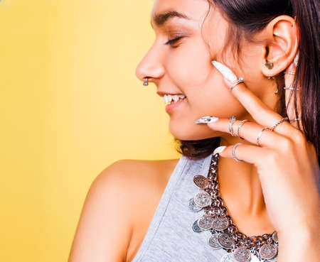 lifestyle people concept. young pretty smiling indian girl with long nails wearing lot of jewelry...