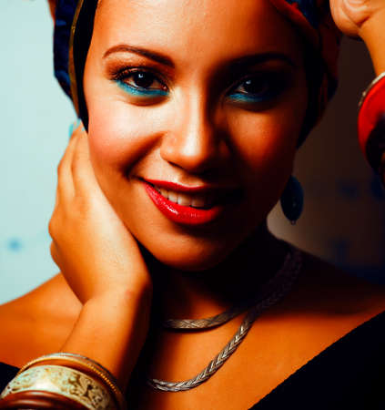 beauty bright african woman with creative make up, shawl on head like cuban woman
