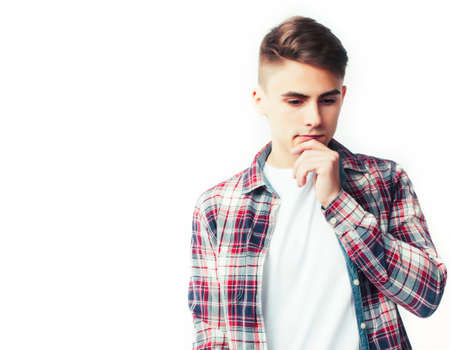 young handsome teenage hipster guy posing emotional, happy smiling against white background isolated, lifestyle people conceptの写真素材