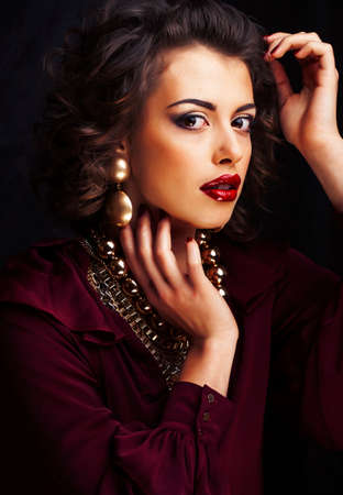 beauty rich woman with bright makeup wearing luxury jewellery on black background, fashion ladyの写真素材