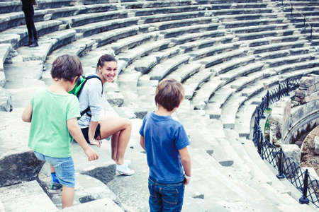 mother with little sons on vacation visiting ancient colosseum, summer tourism, lifestyle people...
