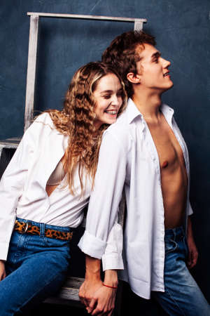 young pretty boy and girl friends happy smiling together in interior, emotional couple, lifestyle people conceptの写真素材