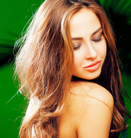 young cute blonde woman on green palm background smiling happy, lifestyle peole conceptの写真素材