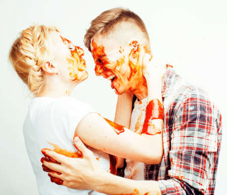 young pretty couple, lifestyle people concept: girlfriend and boyfriend cooking together, having fun, making mess isolated on white backgroundの写真素材
