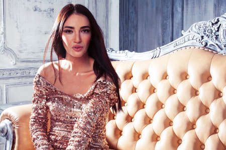 young pretty brunette woman posing in luxury hotel room interior, lifestyle rich people conceptの写真素材