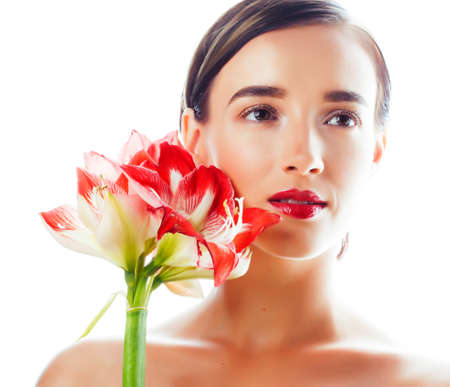 young pretty brunette real woman with red flower amaryllis isolated on white backgroundの写真素材