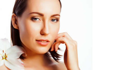 young pretty woman with big white flower close up isolated on white, hands manicure, spa people conceptの写真素材