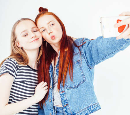 best friends teenage girls together having fun, posing emotional on white background, besties happy smiling, lifestyle people conceptの写真素材