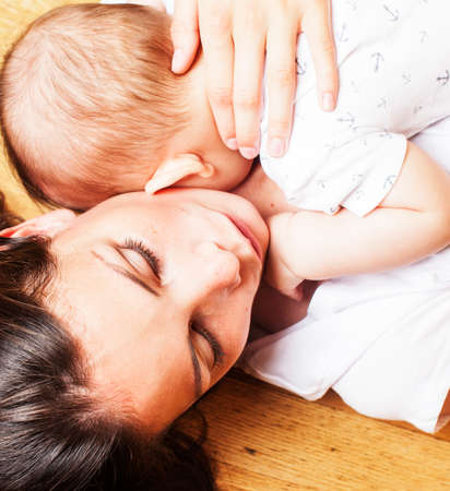 young brunette happy mother holding toddler baby son, breast-feeding concept, people lifestyle