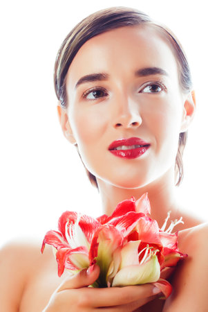young pretty brunette real woman with red flower amaryllis isolated on white backgroundの写真素材