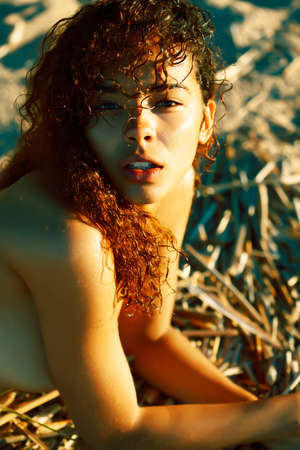 young pretty african curly girl on sunset on beach sexy looking, lifestyle people conceptの写真素材