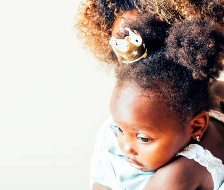 adorable sweet young african-american mother with cute little daughter, hanging at home, having fun playing smiling, lifestyle people concept, happy smiling modern familyの写真素材