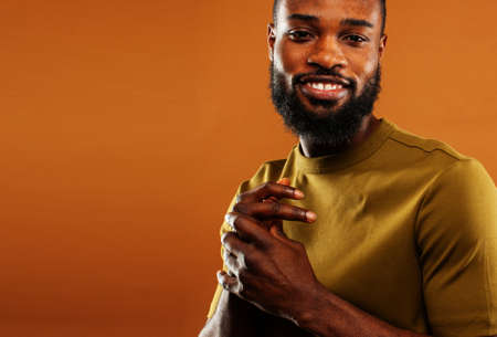 young pretty african american man posing cheerful on brown background, lifestyle people conceptの写真素材