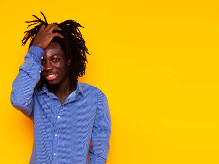 young handsome african american guy student posing cheerful and gesturing on yellow background, lifestyle people conceptの写真素材