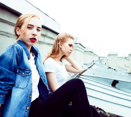 two cool blond real girls friends making selfie on roof top, lifestyle people concept, modern teensの写真素材