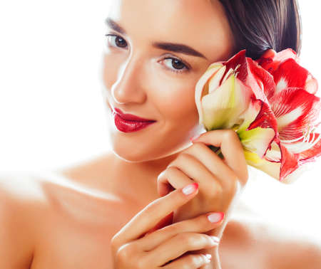 young pretty brunette real woman with red flower amaryllis isolated on white backgroundの写真素材