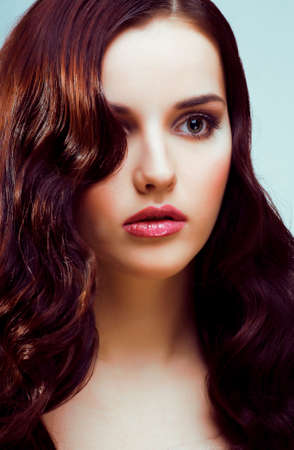 young pretty woman with hairstyle waves, luxury fashion make up look on white backgroundの写真素材