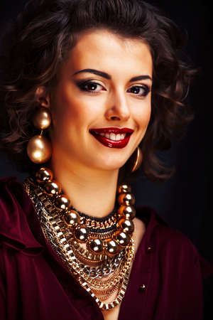 beauty rich woman with bright makeup wearing luxury jewellery on black background, fashion ladyの写真素材