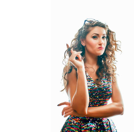 young brunette woman with curly hairstyle in fancy glamur dress isolated on white background gesturing emotional crazyの写真素材