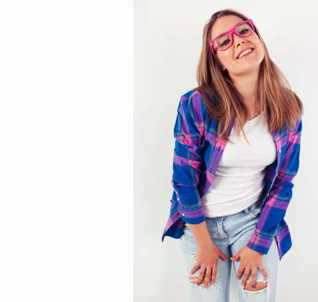 young pretty brunette real girl hipster on white background casual close up dreaming isolated smilingの写真素材