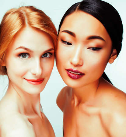 different nation woman: caucasian and asian together isolated on white background happy smiling, diverse type on skin, lifestyle people conceptの写真素材