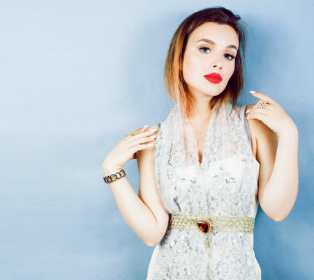young pretty woman with blond hair on blue background, sensual make up elegant lookの写真素材
