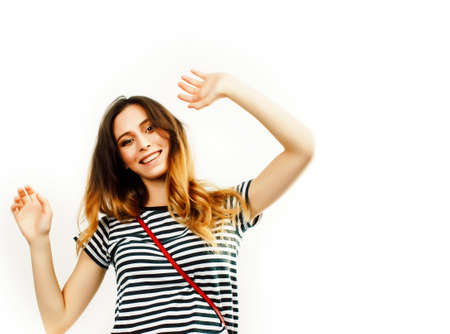 young pretty teenage hipster girl posing emotional happy smiling on white background, lifestyle people conceptの写真素材