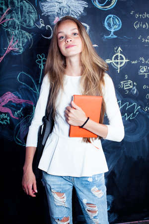 back to school after summer vacations, cute teen girl in classroomの写真素材