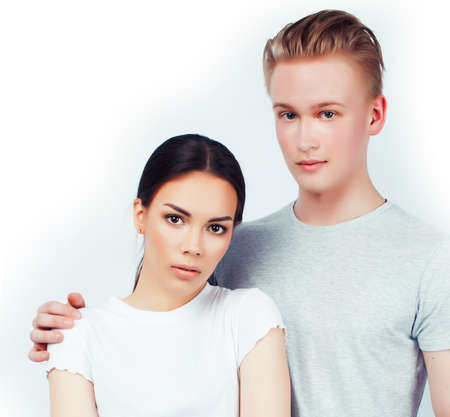 modern hipster guys together couple diverse nations, asian girl and caucasian blond boy isolated on white background, lifestyle people conceptの写真素材