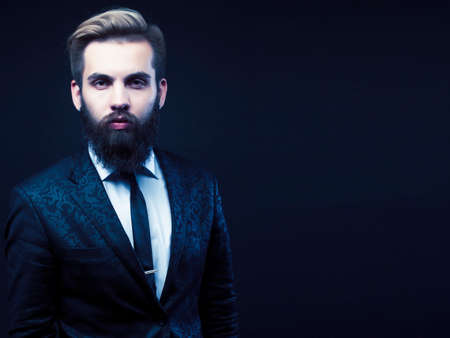 young attractive bearded hipster man gesturing emotional screaming in studio sucsess. fashion modern brutal guyの写真素材