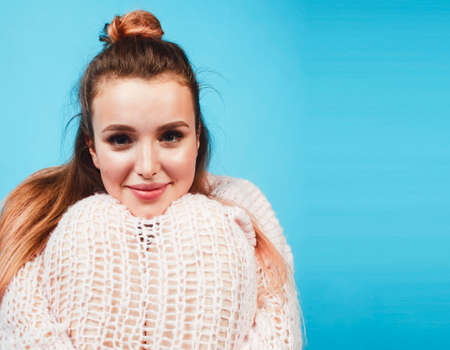 young pretty teenage modern hipster girl posing emotional happy on blue background, lifestyle people conceptの写真素材