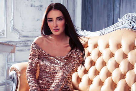 young pretty brunette woman posing in luxury hotel room interior, lifestyle rich people conceptの写真素材