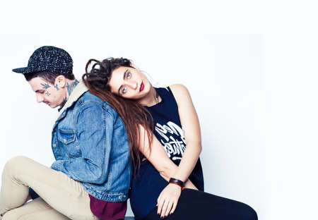 Young couple together. guy with tattoo, girlfriend wearing dreadlocks having fun on white backgroundの写真素材