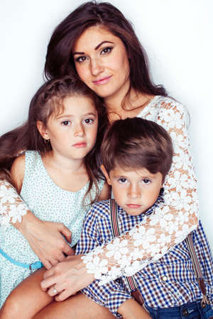 young mother with two children on white background isolated, happy smiling family, lifestyle people conceptの写真素材