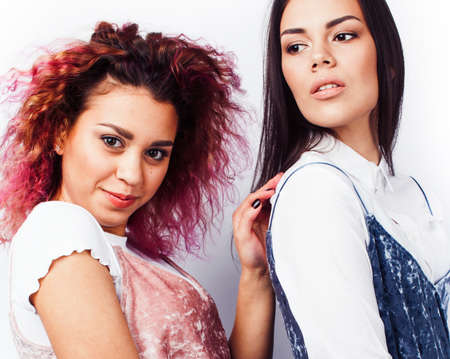 best friends teenage girls together having fun, posing emotional isolated on white background, asian and latin american woman cheerful, lifestyle people conceptの写真素材